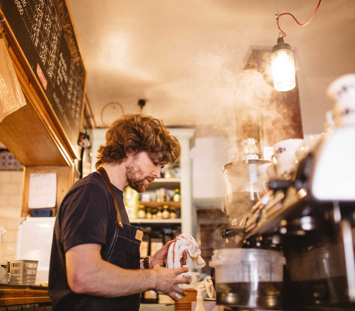 barista steaming the machine